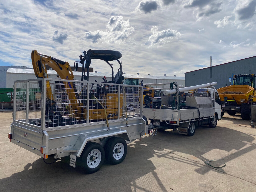 Mini excavator with transport and equipment context